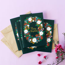 Load image into Gallery viewer, &#39;Merry Christmas&#39; hand lettering surround by a lush Christmas wreath made of NZ flora and holly, all set against a deep green background.